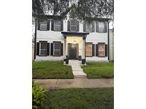Charming two-story home with black shutters and well-manicured front yard at 5231 Lemon Twist Ln, Windermere, FL 34786