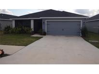 Charming single-Gathering home featuring an attached two-car garage and well-maintained landscaping at 621 Vittorio Dr, Winter Haven, FL 33884