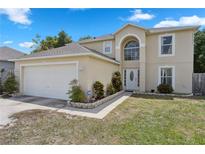 Inviting two-story home with a two-car garage and manicured front yard at 1526 Ferendina Dr, Deltona, FL 32725