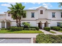 Inviting townhome exterior with well-manicured landscaping and a charming tile roof at 1565 Plunker Dr, Davenport, FL 33896