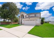 Charming two-story home with a well-manicured lawn and a two-car garage at 2503 Calla Lily Cv, Kissimmee, FL 34758