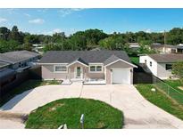 Aerial view of a one-story home with a private driveway and well manicured lawn at 2629 Williston Dr, Lakeland, FL 33801