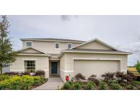 Charming two-story home with a two car garage, landscaped yard and welcoming front entrance at 5225 Tuscany Ln, Davenport, FL 33897