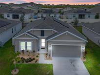 Charming single-Gathering home featuring a well-manicured lawn, two-car garage, and welcoming front entrance at 757 Citrus Reserve Blvd, Davenport, FL 33837