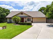 Charming single-story home featuring a well-manicured lawn, stone accents, and a two-car garage at 1016 Ohanlon Ct, Oviedo, FL 32765