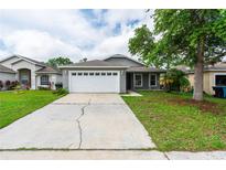 Charming single-story home featuring a spacious two-car garage and a well-maintained front yard at 1659 Sage Creek Ct, Orlando, FL 32824