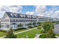 Charming multi-story townhome showcasing well-manicured lawns and beautiful landscaping at 1845 Island Village Way, Celebration, FL 34747