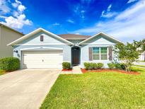 Charming single-Gathering home with a well-manicured lawn and inviting curb appeal under a beautiful sky at 2839 Harmonia Hammock Rd, Harmony, FL 34773