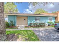Charming single-story villa with a covered entryway, manicured landscaping, and a private parking space at 4768 Tangerine Ave # 4768, Winter Park, FL 32792