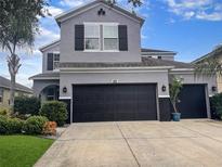 Charming two-story home with well-maintained landscaping and a spacious two-car garage at 12606 Old Plantation Ln, Orlando, FL 32824