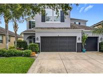 Charming home featuring a spacious garage and well-manicured lawn with flowering plants at 12606 Old Plantation Ln, Orlando, FL 32824