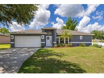 Charming single-story home with a well-manicured lawn and inviting curb appeal at 138 Hidden Pointe Ln, Groveland, FL 34736