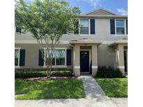 Charming townhome featuring a well-manicured lawn and a welcoming entrance at 1868 Katz Crossing Dr, Kissimmee, FL 34744