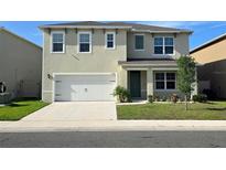 Charming two-story home with a well-manicured lawn and attached two-car garage at 2722 Numa Falls Ave, Davenport, FL 33837