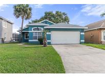 Charming single-story home featuring a well-manicured lawn and attached two car garage at 3228 Fairfield Dr, Kissimmee, FL 34743