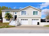 Charming two-story home with white siding, two-car garage and well-maintained front yard at 4151 Nelson Rd, Lake Wales, FL 33898