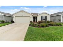 Charming single story home featuring an attached two car garage and well maintained front yard at 4338 Finch Ln, Kissimmee, FL 34746