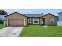 Charming single-story home with a well-manicured lawn and a two-car garage at 1118 Saint Tropez Ct, Kissimmee, FL 34759