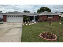 Charming single-story brick home with a well-manicured lawn and a two-car garage at 2013 Marilyn Ave, Winter Haven, FL 33881