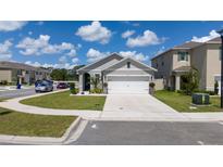 Charming single-Gathering home with a well-maintained lawn, attached two-car garage and neutral color palette at 2211 Tay Wes Dr, St Cloud, FL 34771