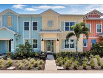Charming, colorful two-story home with a landscaped front yard, evoking a welcoming and vibrant curb appeal at 2993 Caribbean Soul Dr, Kissimmee, FL 34747