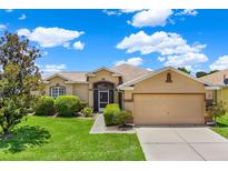 Charming one-story home with manicured lawn, mature landscaping, and a beige color scheme at 4244 Windchime Ln, Lakeland, FL 33811