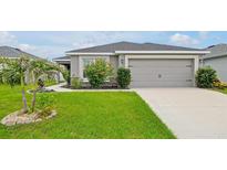 Beautiful single Gathering home featuring a well maintained lawn and a two car garage at 4505 Hummingbird Ln, Haines City, FL 33844