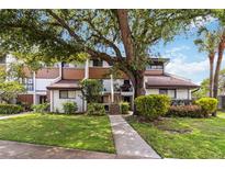 Inviting townhouse featuring mature landscaping and a well-maintained lawn and walkway at 4570 Tower Pine Rd # Ge, Orlando, FL 32839