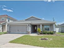 Charming single-story home featuring a well-maintained lawn, neutral paint, and an attached two-car garage at 546 Lorient Dr, Eagle Lake, FL 33839