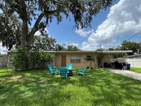 Charming single-story home with a well-manicured front yard and a cozy fire pit area for outdoor enjoyment at 760 Bearcreek Dr, Bartow, FL 33830