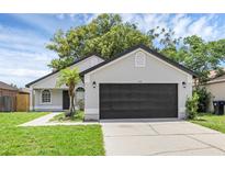 Charming single Gathering home with a well-manicured lawn and a two-car garage at 946 Little Creek Rd, Orlando, FL 32825