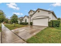 A beautiful single-Gathering home featuring a two-car garage and well-manicured landscaping at 954 Revere Ave, Haines City, FL 33844
