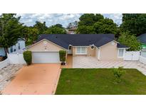 Charming single-story home with well-manicured lawn and neutral-colored exterior at 112 Rosewood Ct, Kissimmee, FL 34743