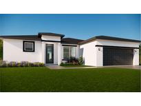 Beautiful single-story home with white stucco, black trim, and a well-manicured lawn at 14967 Sw 43Rd St, Ocala, FL 34473