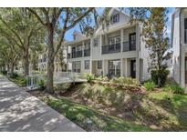 Charming townhome featuring a white bridge walkway and a balcony at 1607 Wilson Ave, Orlando, FL 32804