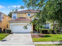 Charming two-story home featuring a two-car garage, well-maintained landscaping, and a welcoming entrance at 195 Hideaway Beach Ln, Kissimmee, FL 34746