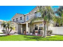 Charming two-story home featuring a well-manicured lawn and tropical landscaping, creating a welcoming curb appeal at 2024 Bearing Ln, Kissimmee, FL 34744