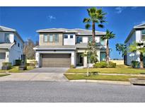 Stunning two-story home with manicured lawn and attached two car garage at 2673 Calistoga Ave, Kissimmee, FL 34741