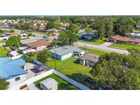 A vibrant aerial view of a home showcasing its spacious yard and neighborhood setting at 2830 W Oak St, Kissimmee, FL 34741