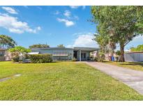 Charming single-story home with a well-maintained lawn, covered parking, and inviting curb appeal at 2830 W Oak St, Kissimmee, FL 34741