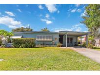 Charming single-story home with a well-maintained lawn, and a covered carport at 2830 W Oak St, Kissimmee, FL 34741