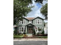 Inviting two-story home featuring a lush front yard and a classic American flag display at 3339 Primrose Willow Dr, St Cloud, FL 34773