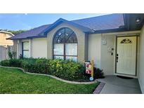 Charming home exterior featuring a well-manicured lawn and a welcoming front entrance at 4830 Red Bay Dr, Orlando, FL 32829