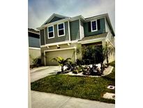 Charming two-story home with well-maintained landscaping, a two-car garage, and neutral paint at 5519 Braken Fern Way, Leesburg, FL 34748