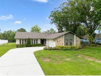 Charming single-story home featuring a stone facade, well-manicured lawn, and a long driveway at 6161 Bass Hwy, St Cloud, FL 34771