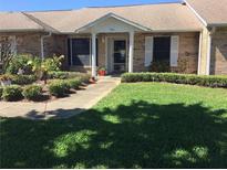 Charming single-story brick home featuring a well-manicured lawn and colorful landscaping, offering great curb appeal at 904 Michigan Ave, St Cloud, FL 34769