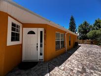 Charming home exterior with well-maintained landscaping and a welcoming entrance at 10207 Cody Ln, Orlando, FL 32825