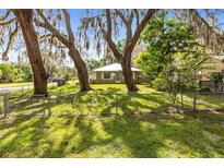 Charming home with mature trees and a fenced yard, offering a peaceful and inviting curb appeal at 1101 Oregon Ave, St Cloud, FL 34769