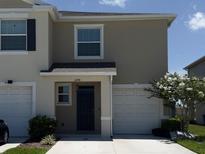 Charming two-story home featuring a well-maintained front yard and attached one-car garage at 2278 Tay Wes Dr, St Cloud, FL 34771
