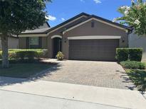 Charming single-story home featuring a brick driveway and well-maintained landscaping at 2436 Gratia Pl, Casselberry, FL 32707